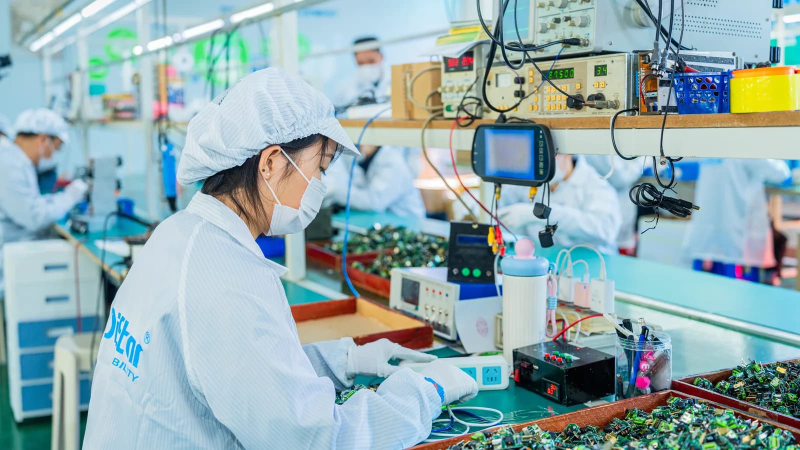 Technician assembling vehicle electronics